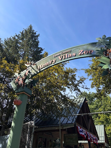 Entrance sign to the Henry Vilas Zoo in Madison, Wisconsin, surrounded by trees on a sunny day, photographed during a Social and Moral Learning Lab outreach event.