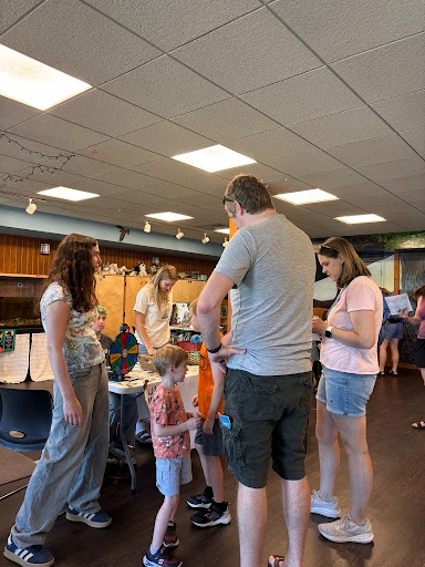Social and Moral Learning Lab members speak with families and children during a community outreach event at the Lussier Family Heritage Center.
